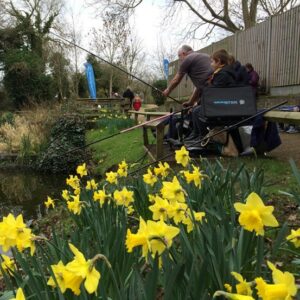 Get Fishing | Spring into Fishing - family fishing on a pool with daffodils