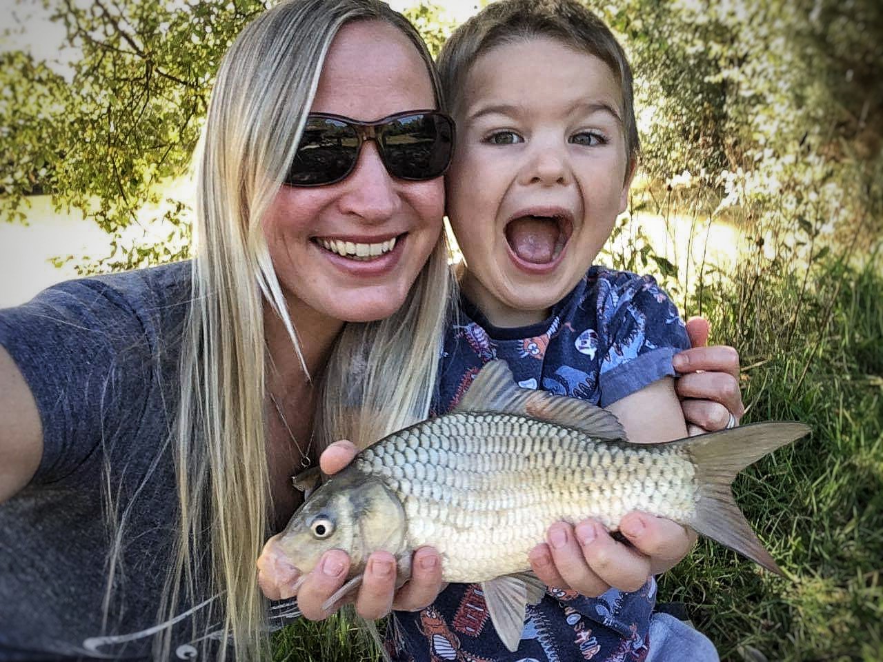 Get Fishing | Zenia with her son and a carp