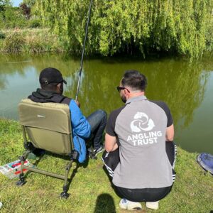 Get Fishing | Jack helping a newcomer to learn to fish